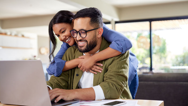 AdobeStock_1088699149 Smiling St. Louis couple reviewing finances with Gateway Metro Federal Credit Union